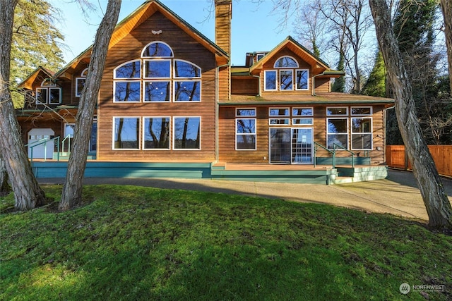 back of property featuring a lawn