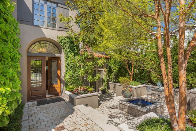 doorway to property with a patio area