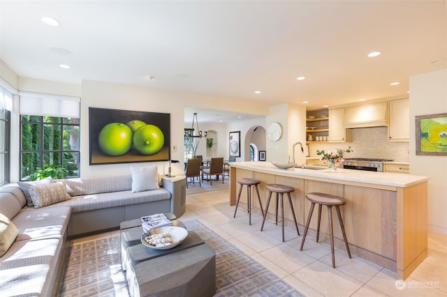 tiled living room featuring sink