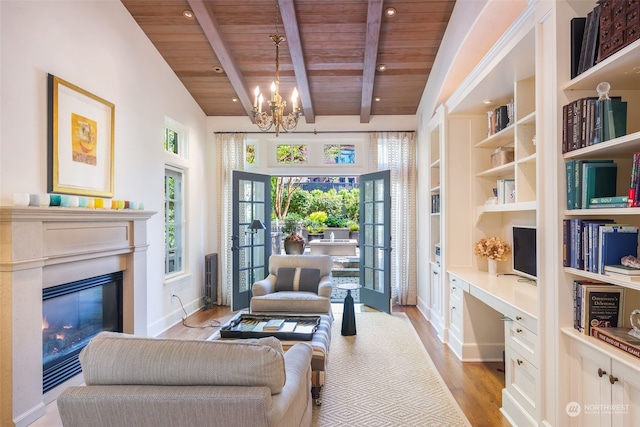 living area featuring light hardwood / wood-style flooring, built in features, built in desk, wooden ceiling, and beamed ceiling