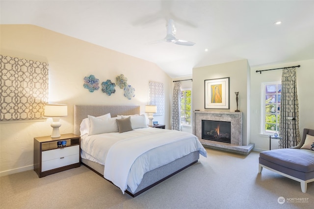 bedroom with ceiling fan, vaulted ceiling, and light carpet