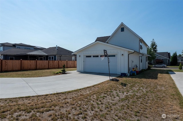 view of side of property with a garage and a yard