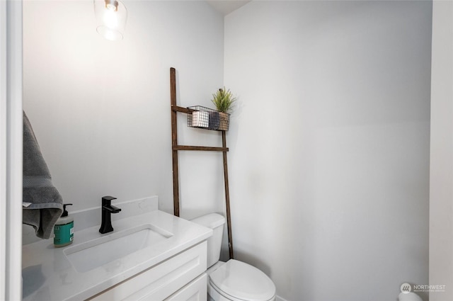 bathroom featuring toilet and vanity