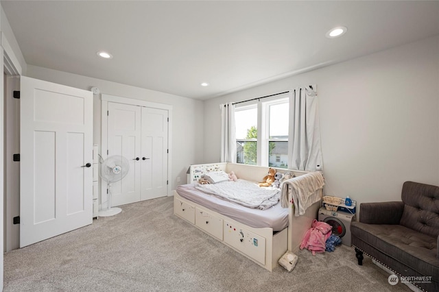 carpeted bedroom with a closet