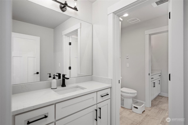 bathroom with toilet and vanity