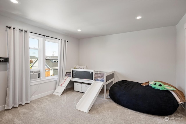 bedroom with light carpet and cooling unit