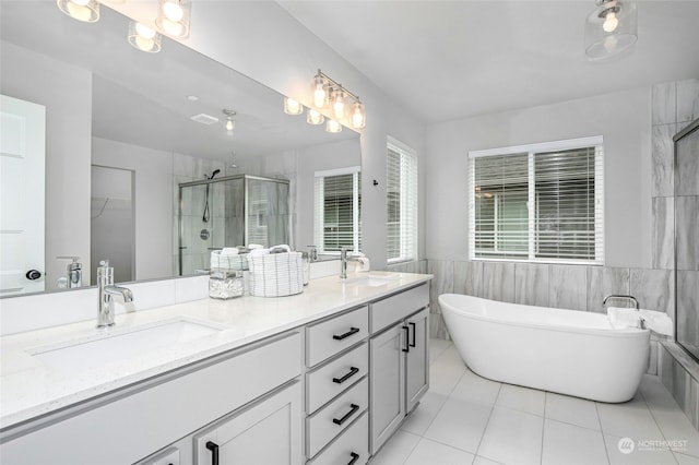 bathroom featuring vanity, tile patterned floors, tile walls, and separate shower and tub