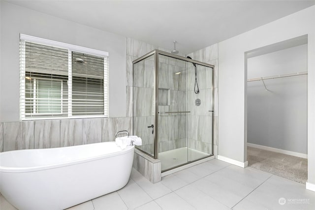 bathroom featuring tile patterned flooring and plus walk in shower