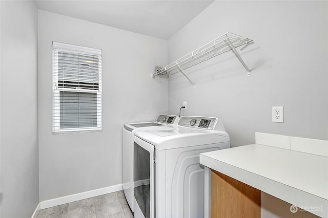 clothes washing area with washer and clothes dryer and a healthy amount of sunlight