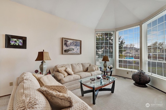 living area featuring light colored carpet, vaulted ceiling, visible vents, and baseboards