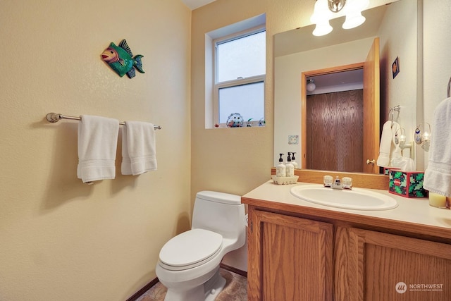 half bathroom with vanity and toilet