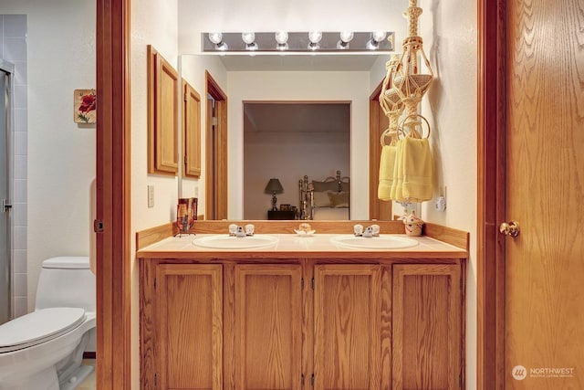 full bathroom featuring a sink, toilet, and double vanity