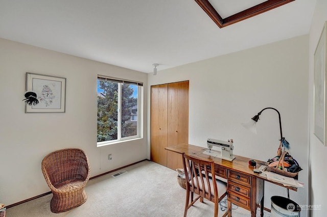 carpeted office space featuring visible vents and baseboards