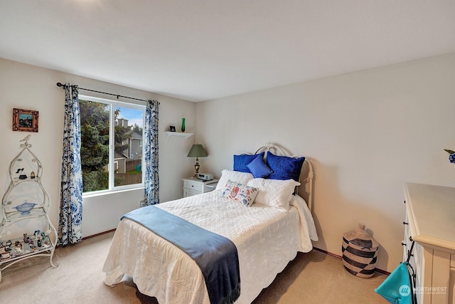 carpeted bedroom featuring baseboards