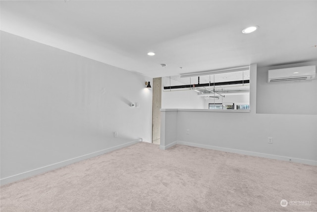 carpeted spare room featuring a wall unit AC