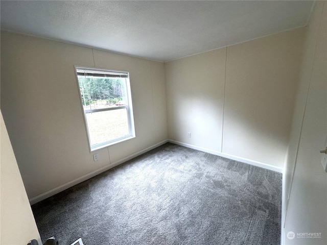 carpeted spare room with a textured ceiling