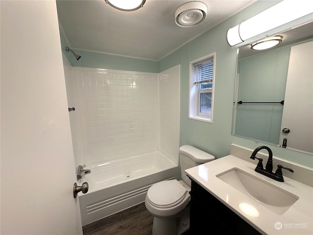 full bathroom featuring shower / washtub combination, hardwood / wood-style flooring, vanity, toilet, and a textured ceiling