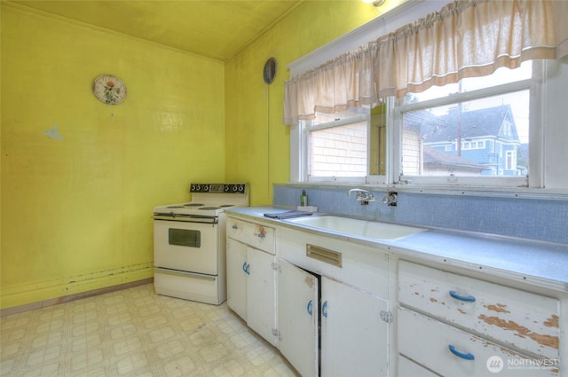 kitchen featuring white electric range, a sink, white cabinets, light countertops, and light floors