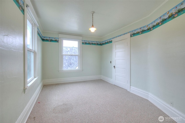 spare room with baseboards and carpet floors