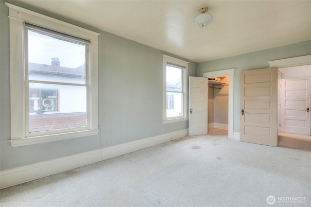 unfurnished bedroom with a closet, baseboards, and carpet