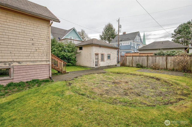 view of yard with an outdoor structure and fence