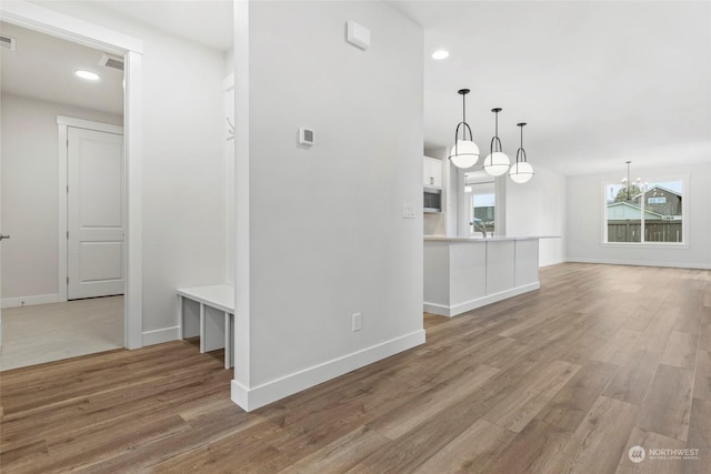 interior space featuring a chandelier and light hardwood / wood-style flooring