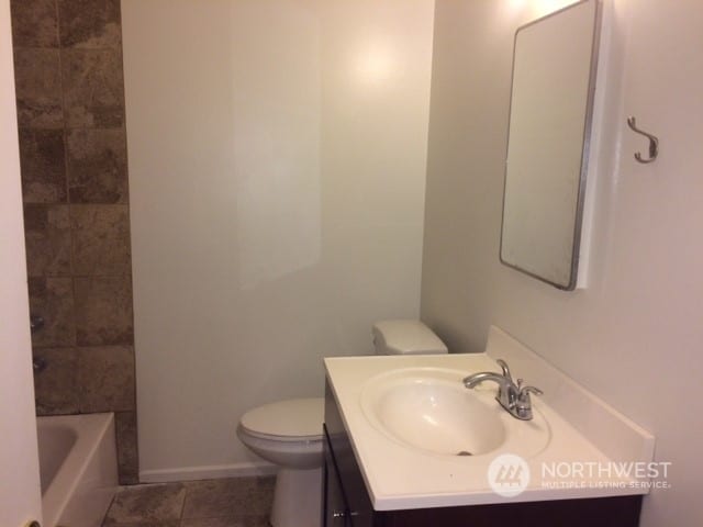 full bathroom featuring toilet, tile patterned flooring, plus walk in shower, and vanity