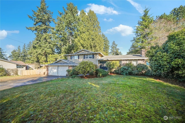 tri-level home with a garage and a front yard