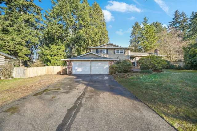 view of front of house featuring a garage and a front lawn