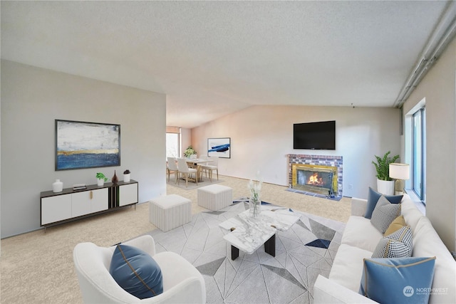 living room with a brick fireplace, vaulted ceiling, light colored carpet, and a textured ceiling