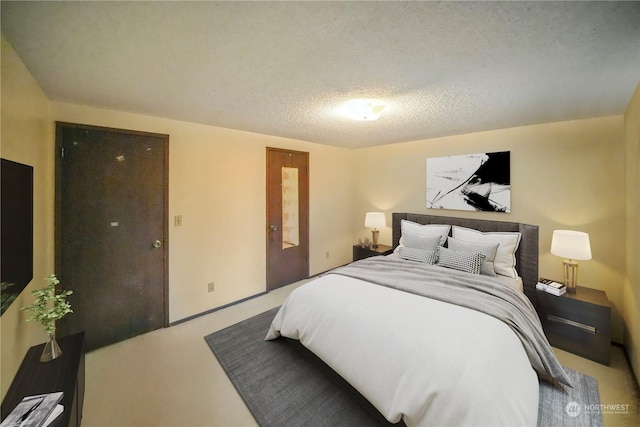 carpeted bedroom featuring a textured ceiling