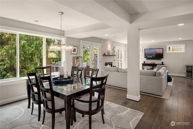 dining area with beverage cooler, dark hardwood / wood-style flooring, and a fireplace