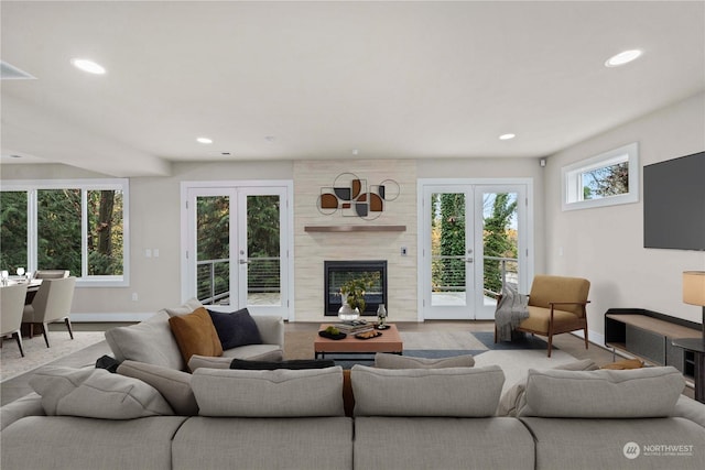 living room with french doors and a high end fireplace