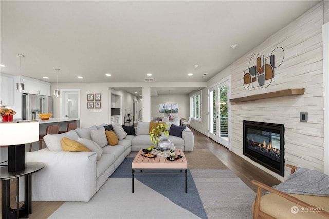 living room featuring hardwood / wood-style floors and a tiled fireplace