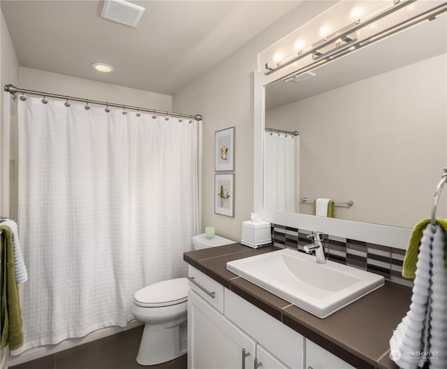 bathroom with toilet, tasteful backsplash, and vanity