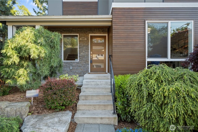 property entrance with stone siding