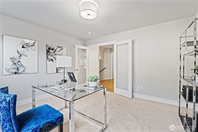 office area featuring baseboards and carpet flooring