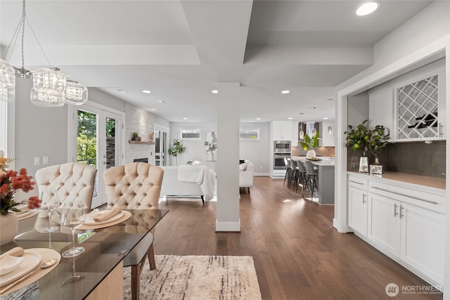 interior space with recessed lighting, dark wood-style flooring, and a notable chandelier