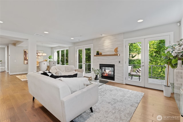 living area featuring french doors, recessed lighting, light wood-style flooring, and visible vents