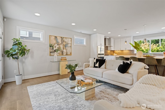 living room with plenty of natural light, recessed lighting, and baseboards