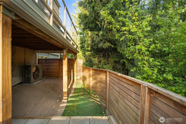 view of side of property with a fenced backyard and ac unit