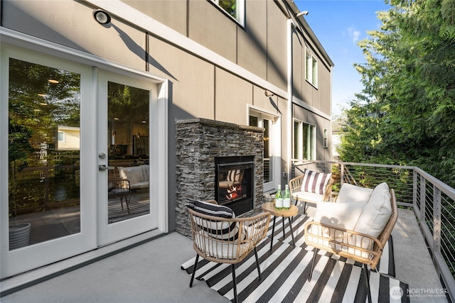 exterior space featuring an outdoor stone fireplace and french doors