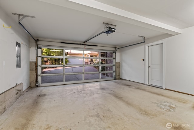 garage with a garage door opener and electric panel