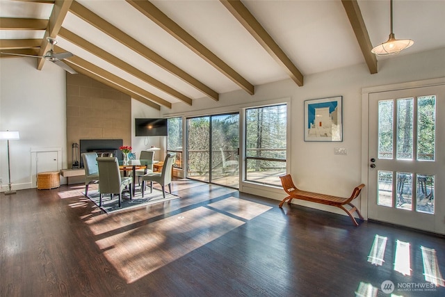 dining room featuring beam ceiling, plenty of natural light, high vaulted ceiling, and wood finished floors