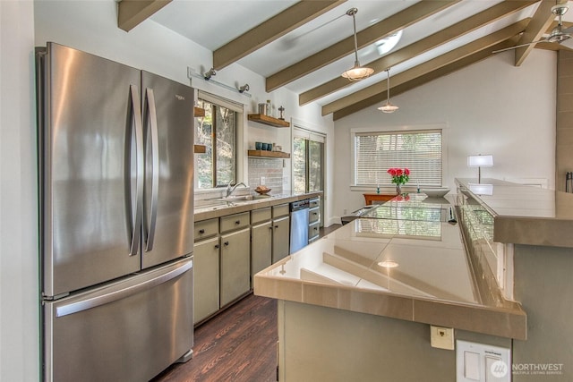 kitchen featuring tile countertops, pendant lighting, lofted ceiling with beams, dark wood-style floors, and stainless steel appliances