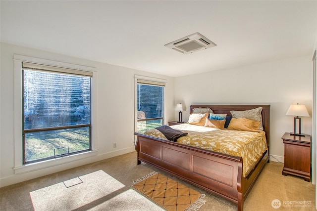 bedroom with light carpet and baseboards