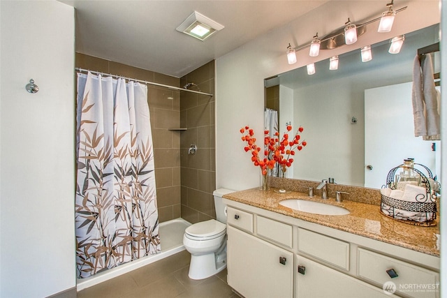 bathroom with tile patterned flooring, toilet, vanity, and a shower with curtain