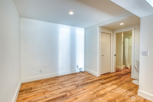 spare room with recessed lighting, light wood-style floors, and baseboards