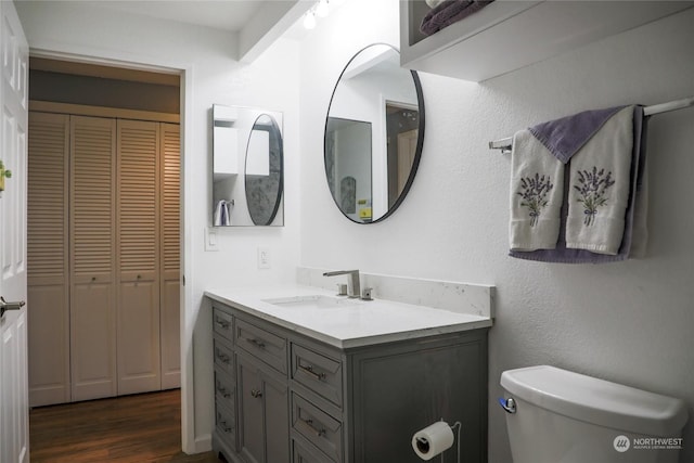 bathroom featuring hardwood / wood-style floors, toilet, and vanity