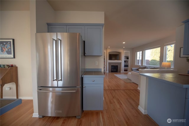 kitchen featuring high quality fridge, gray cabinetry, and light hardwood / wood-style floors